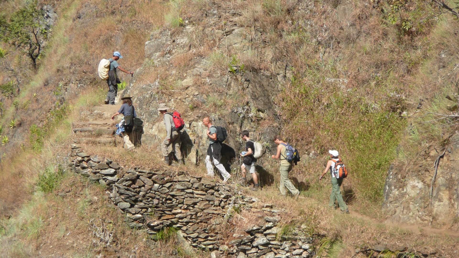 Hikers climbing stone steps on the Inca Trail with backpacks