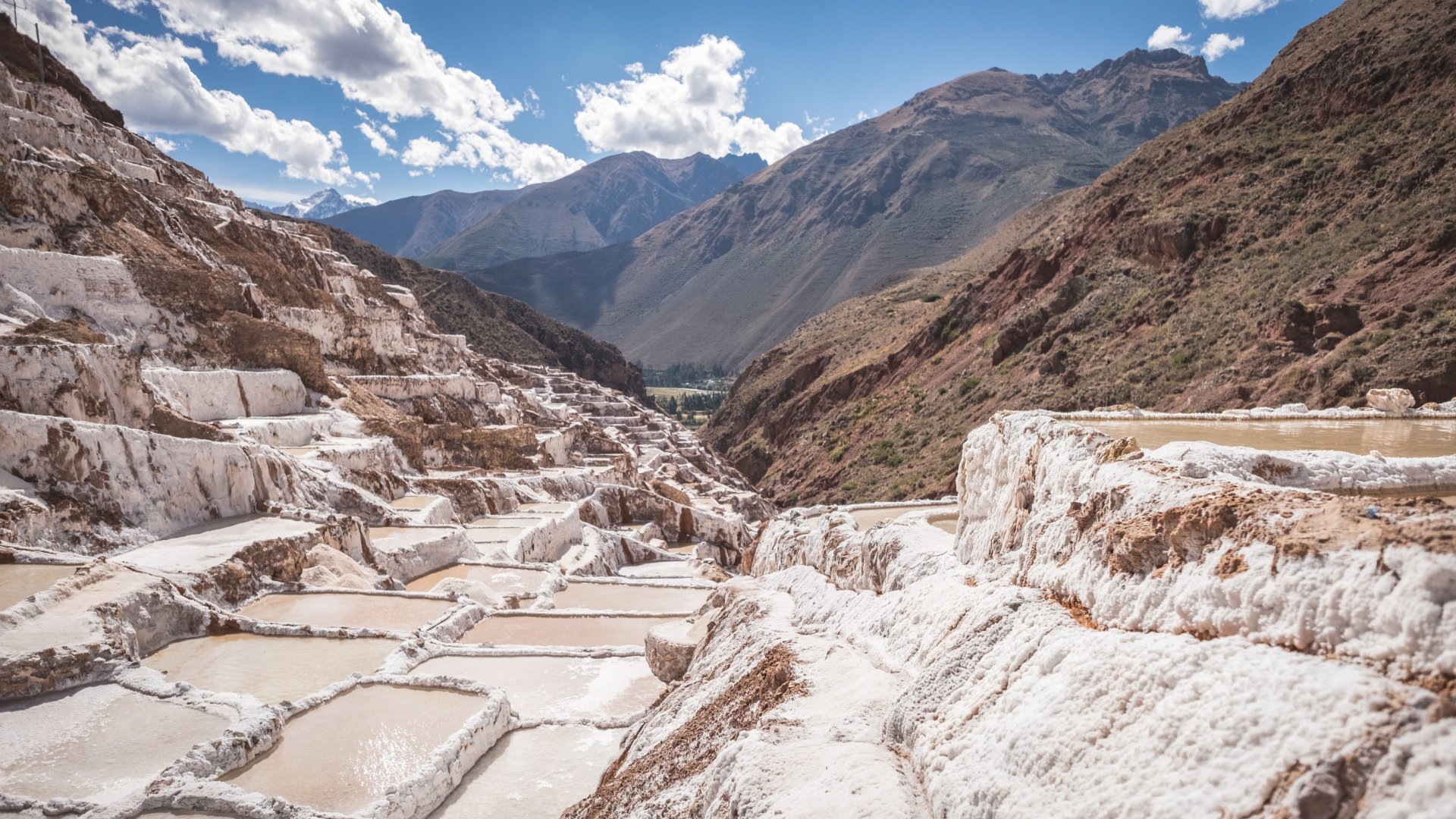 Salineras de Maras salt terraces in Sacred Valley, Peru, with white salt pools on mountain slopes near Cusco